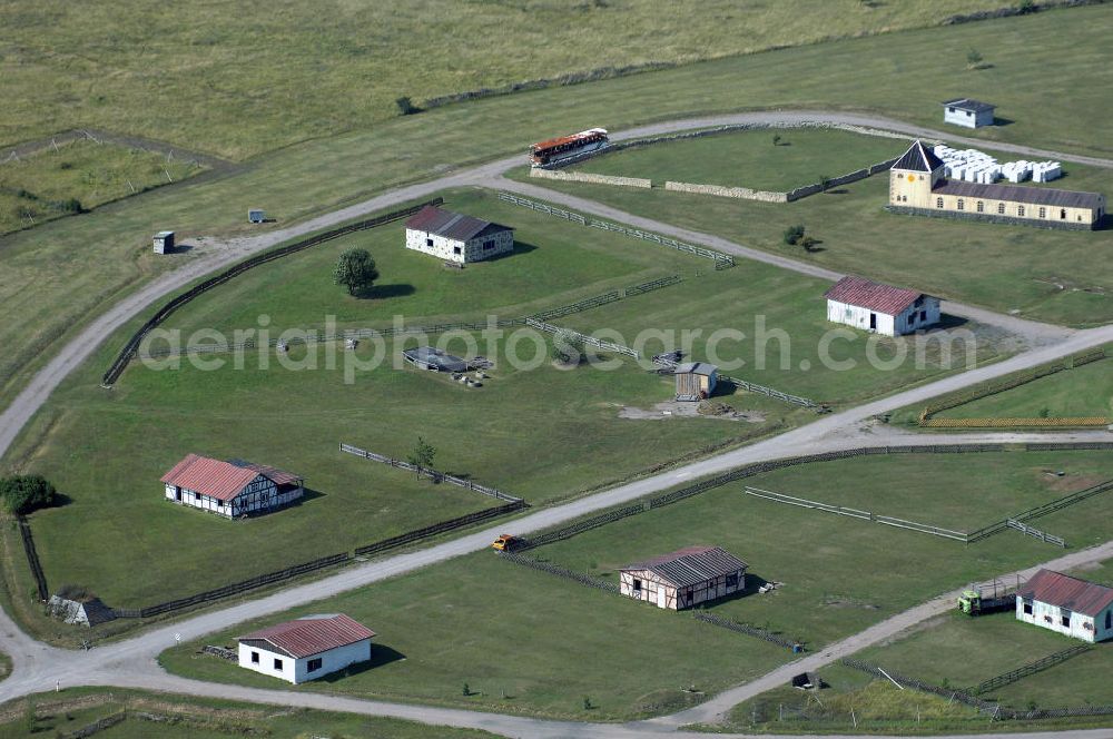 OHRDRUF from above - Blick auf das Areal des Häuserkampfgeländes auf dem Truppenübungsplatz Ohrdruf der Bundeswehr.Am 5. April 1945 wurde der Truppenübungsplatz von der 4. US-Panzerdivision der 6. US-Armee erobert, sie richteten ein Durchgangslager für entlassene russische Kriegsgefangene ein. Während des Kalten Krieges wurde der Platz von 1947 bis 1991 durch die Gruppe der Sowjetischen Streitkräfte in Deutschland mit bis zu 25.000 Soldaten genutzt, zuletzt durch die 39. Garde Motorisierte-Schützen Division (8. Gardearmee - Nohra). Nach dem Abzug der sowjetischen Truppen wurde am 22. Dezember 1993 der Platz von der Bundeswehr übernommen.