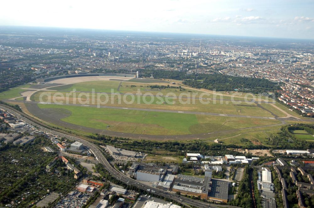 Aerial photograph Berlin - Blick auf das Areal des stillgelegten Flughafen Berlin - Tempelhof mit den beiden Start- und Landebahnen. Neben gelegentlichen Events wie Konzerten und Messen ist das Gelände weitestgehend dem stillen Verfall preisgegeben. Noch sind alle luftverkehrsmäßigen Leit- und Befeuerungsanlagen intakt, aber lokalpolitische Erwägungen zwangen zur Stillegung dieses geschichtsträchtigen Flughafen.