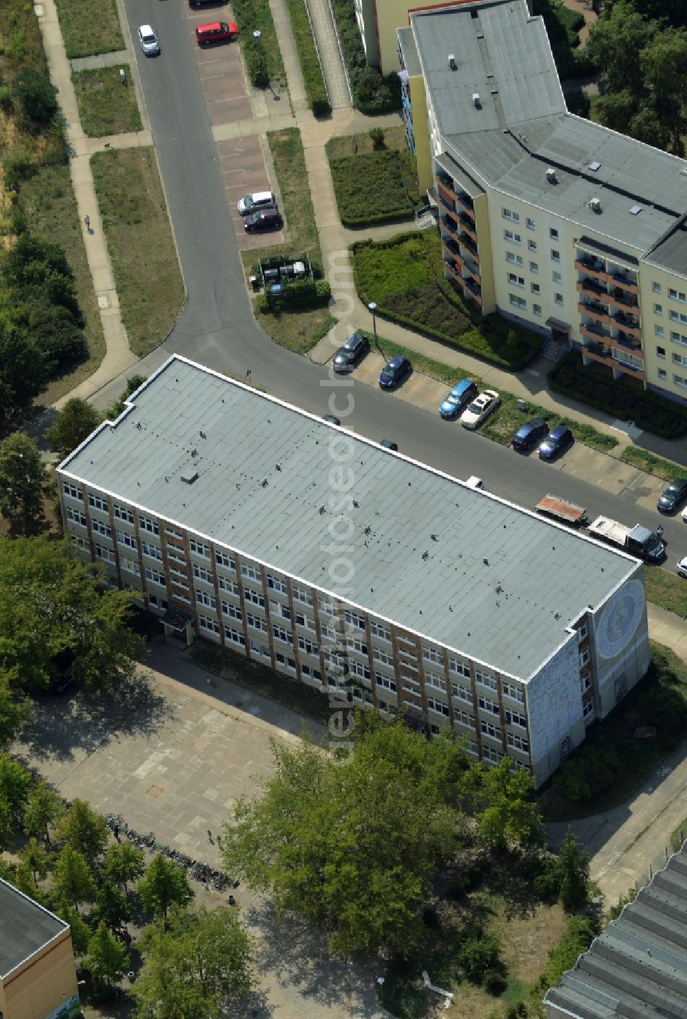 Aerial image Berlin - Home for asylum seekers in a former school building in the district of Marzahn-Hellersdorf in Berlin in Germany. The former Max-Rheinhardt-School is located amidst concrete slab buildings and residential estates on Carola-Neher-Street