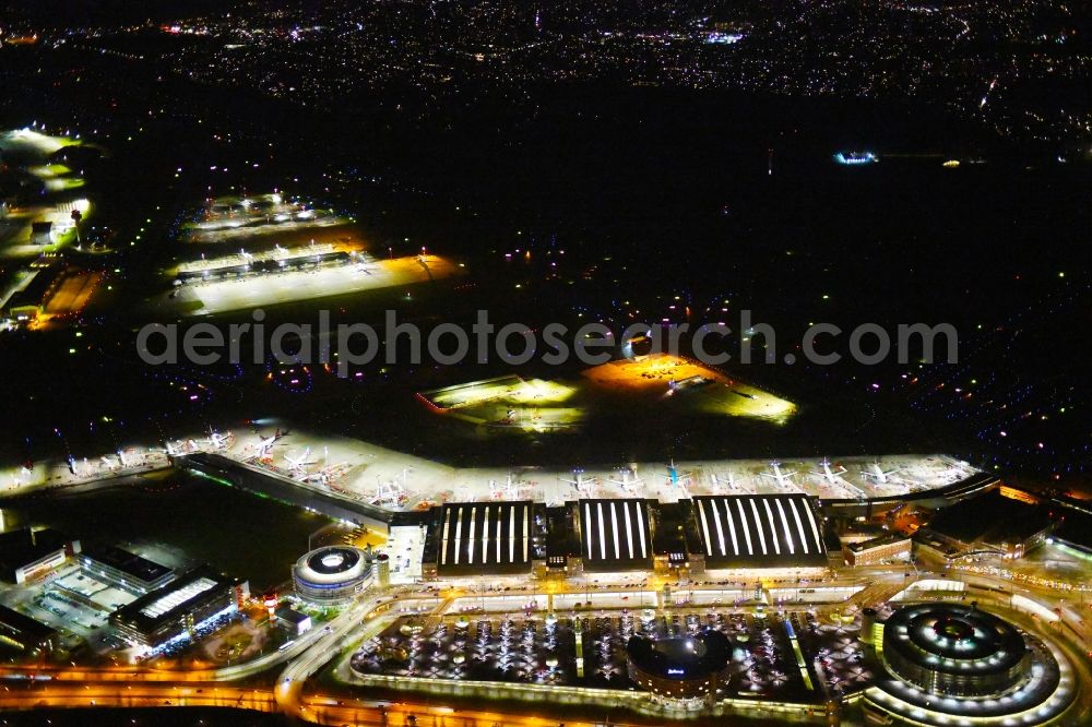 Hamburg at night from above - Night lighting dispatch building and terminals on the premises of the airport Hamburg Airport Helmut Schmidt (ICAO-Code:EDDH) in the district Fuhlsbuettel in Hamburg, Germany