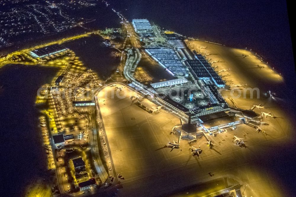 Köln at night from the bird perspective: Night lighting Dispatch building and terminals on the premises of the airport Koeln Bonn Airport on street Kennedystrasse in the district Porz in Cologne in the state North Rhine-Westphalia, Germany