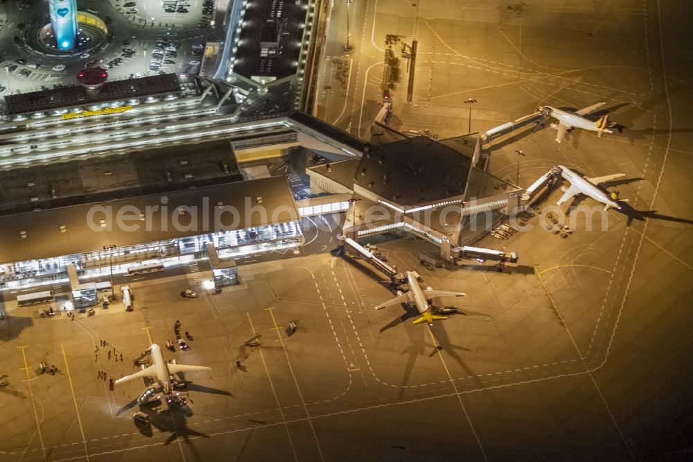 Köln at night from the bird perspective: Night lighting Dispatch building and terminals on the premises of the airport Koeln Bonn Airport on street Kennedystrasse in the district Porz in Cologne in the state North Rhine-Westphalia, Germany