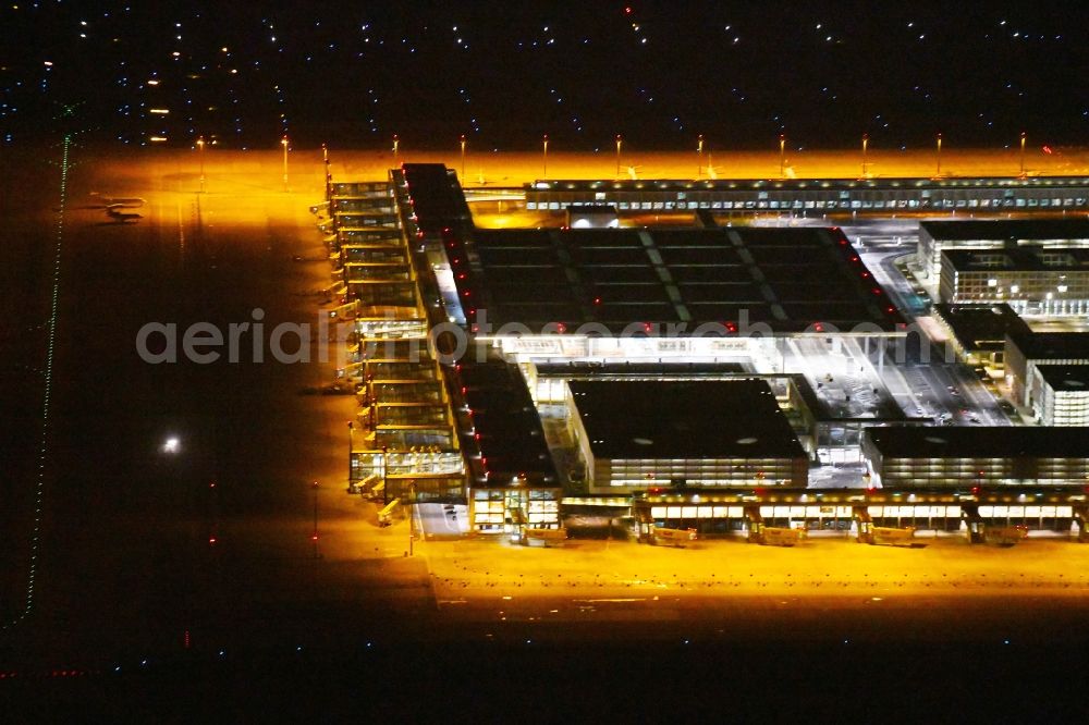 Aerial image at night Schönefeld - Night lighting Dispatch building and terminals on the premises of the airport BER in Schoenefeld in the state Brandenburg