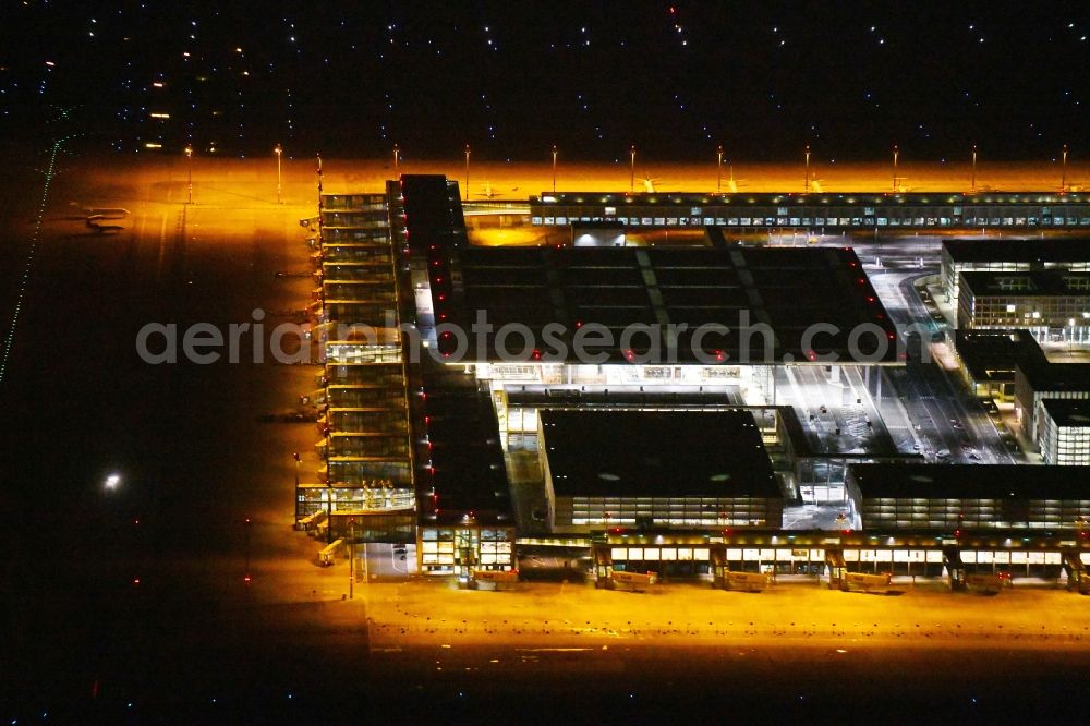 Schönefeld at night from above - Night lighting Dispatch building and terminals on the premises of the airport BER in Schoenefeld in the state Brandenburg