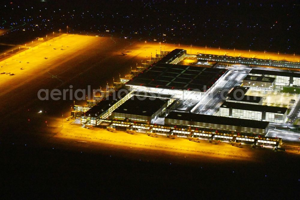 Aerial image at night Schönefeld - Night lighting Dispatch building and terminals on the premises of the airport BER in Schoenefeld in the state Brandenburg