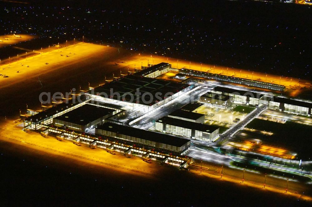 Schönefeld at night from above - Night lighting Dispatch building and terminals on the premises of the airport BER in Schoenefeld in the state Brandenburg