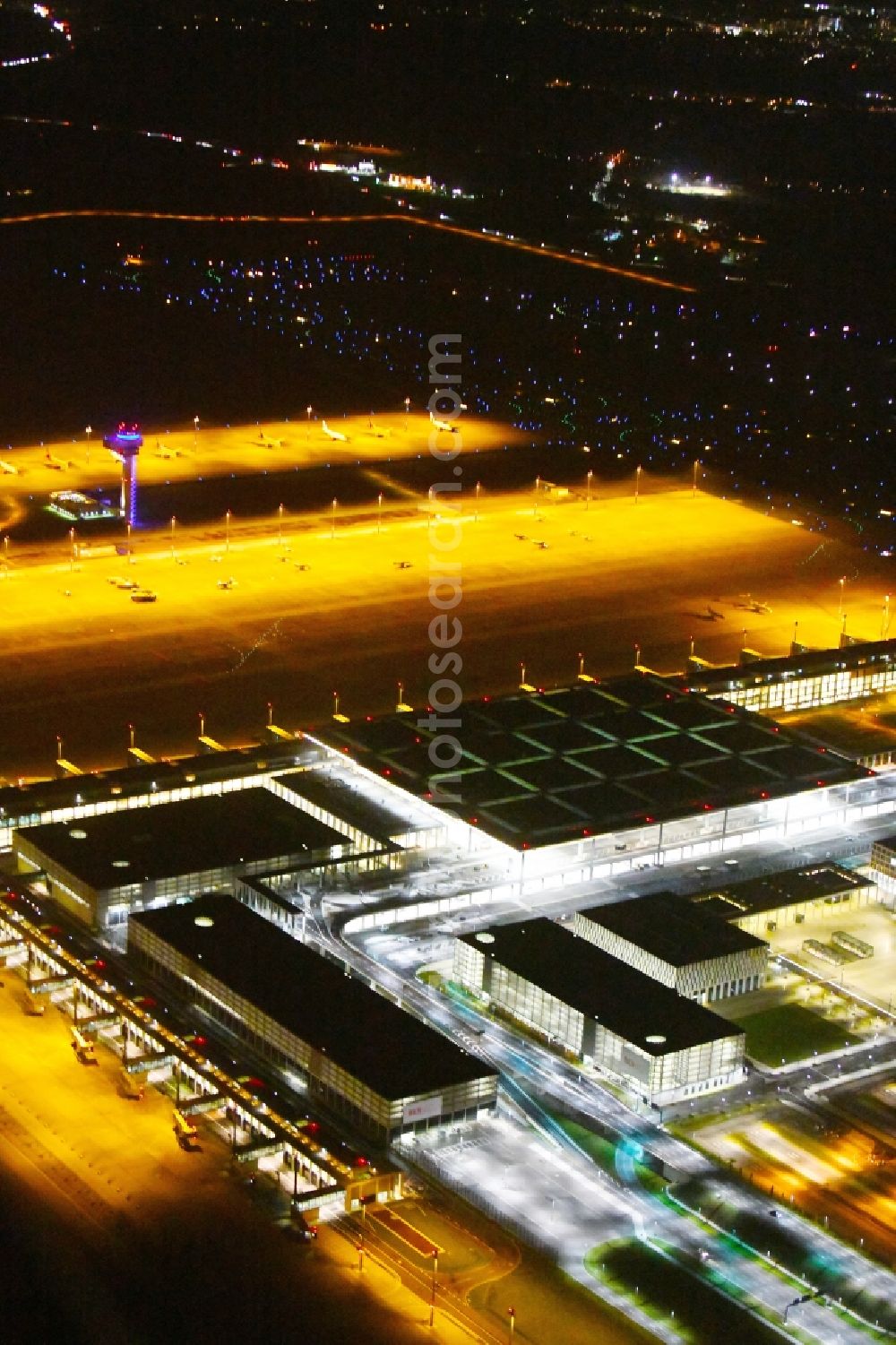 Schönefeld at night from above - Night lighting Dispatch building and terminals on the premises of the airport BER in Schoenefeld in the state Brandenburg