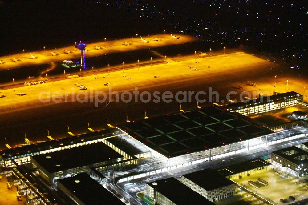 Aerial image at night Schönefeld - Night lighting Dispatch building and terminals on the premises of the airport BER in Schoenefeld in the state Brandenburg