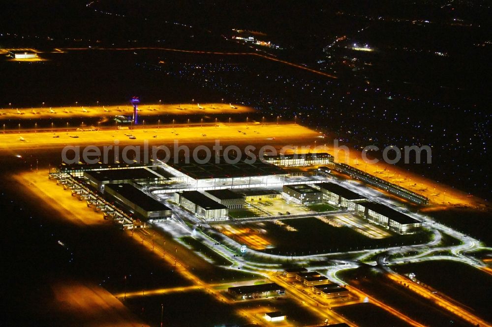 Schönefeld at night from above - Night lighting Dispatch building and terminals on the premises of the airport BER in Schoenefeld in the state Brandenburg