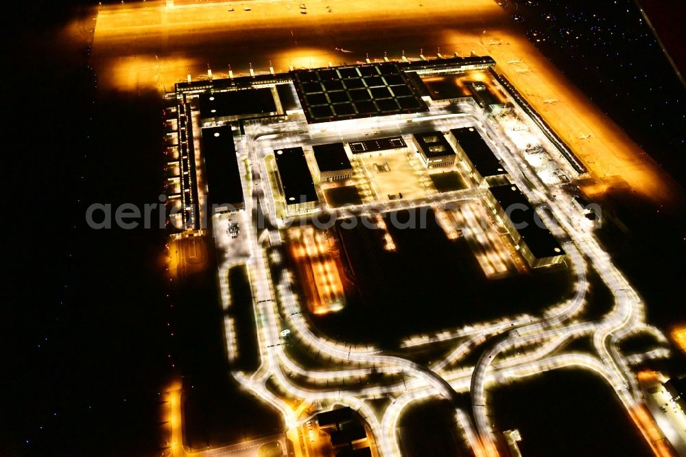 Schönefeld at night from above - Night lighting dispatch building and terminals on the premises of the airport BER in Schoenefeld in the state Brandenburg