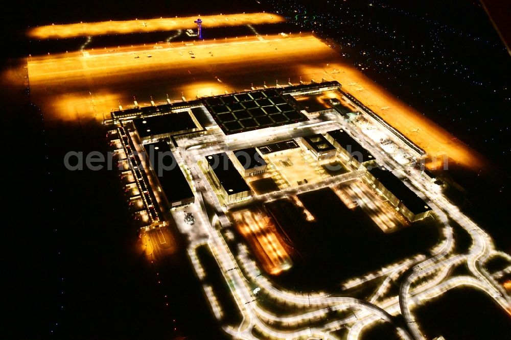 Schönefeld at night from above - Night lighting dispatch building and terminals on the premises of the airport BER in Schoenefeld in the state Brandenburg