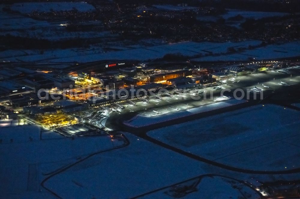 Aerial image at night Stuttgart - Night lighting dispatch building and terminals on the premises of the airport in Stuttgart in the state Baden-Wuerttemberg