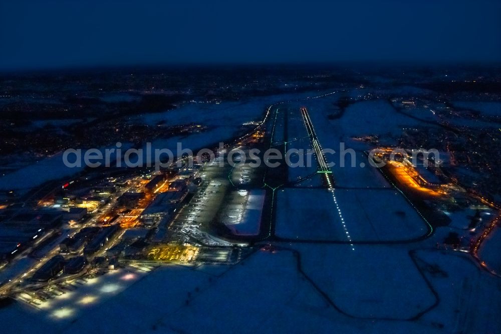 Stuttgart at night from the bird perspective: Night lighting dispatch building and terminals on the premises of the airport in Stuttgart in the state Baden-Wuerttemberg