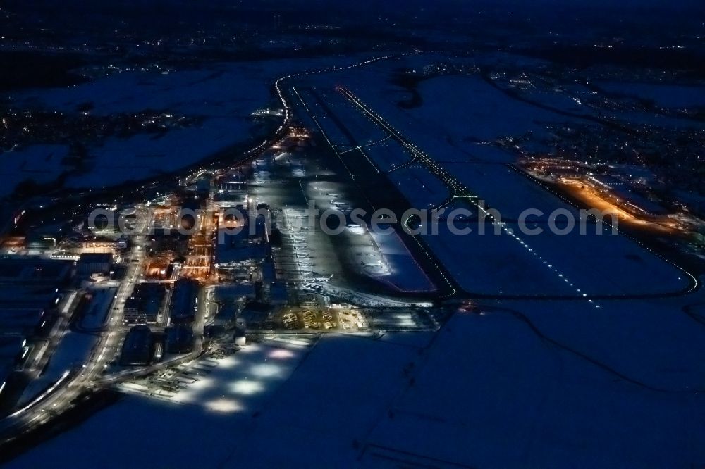 Aerial image at night Stuttgart - Night lighting dispatch building and terminals on the premises of the airport in Stuttgart in the state Baden-Wuerttemberg