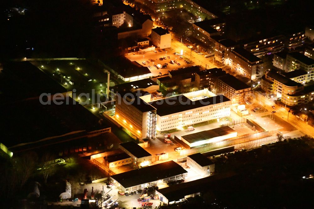 Berlin at night from above - Night lighting prison grounds and security fence of the AHA detention center on street Gruenauer Strasse in the district Koepenick in Berlin, Germany