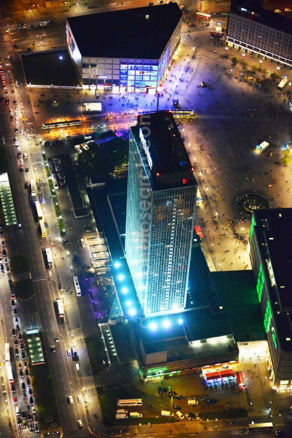 Berlin at night from above - Night aerial view overlooking illuminated buildings at Alexanderplatz in the city center of Berlin. Visible among others are the department stores Saturn and Galeria Kaufhof as well as the Park Inn Hotel