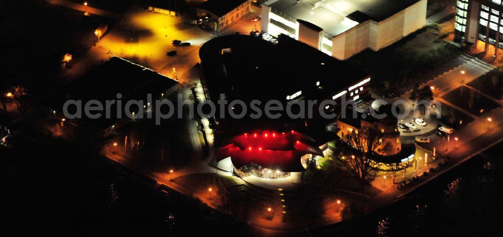 Aerial image at night Potsdam - Nachtluftbild des Areales am Hans Otto Theater auf dem Kultur- und Gewerbestandort in der Schiffbauergasse am Tiefen See in Potsdam. Das 2006 eröffnete Theater ist das Brandenburgischen Landestheaters, das nach dem Vorbild des Sydney Opera House vom Architekten Gottfried Böhm entworfen wurde. Vor dem Neubau steht der aus dem 19. Jahrhundert stammende Turm einer früheren Zichorienmühle, in dem ein Restaurant für gehobene Ansprüche untergebracht ist. View of the Hans Otto Theatre in the cultural and business center in the Schiffbauergasse on the lake Tiefer See in Potsdam. Opened in 2006, the Theatre is the Brandenburg State Theater, designed along the lines of the Sydney Opera House by the architect Gottfried Böhm. Area at the Hans Otto Theatre in Potsdam at night.