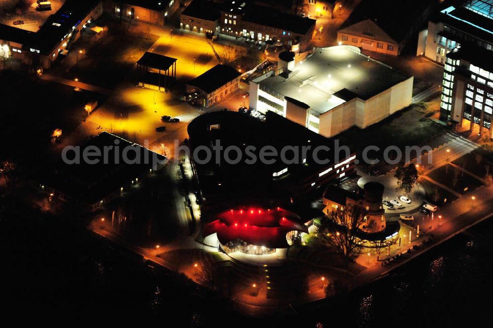 Potsdam at night from above - Nachtluftbild des Areales am Hans Otto Theater auf dem Kultur- und Gewerbestandort in der Schiffbauergasse am Tiefen See in Potsdam. Das 2006 eröffnete Theater ist das Brandenburgischen Landestheaters, das nach dem Vorbild des Sydney Opera House vom Architekten Gottfried Böhm entworfen wurde. Vor dem Neubau steht der aus dem 19. Jahrhundert stammende Turm einer früheren Zichorienmühle, in dem ein Restaurant für gehobene Ansprüche untergebracht ist. View of the Hans Otto Theatre in the cultural and business center in the Schiffbauergasse on the lake Tiefer See in Potsdam. Opened in 2006, the Theatre is the Brandenburg State Theater, designed along the lines of the Sydney Opera House by the architect Gottfried Böhm. Area at the Hans Otto Theatre in Potsdam at night.