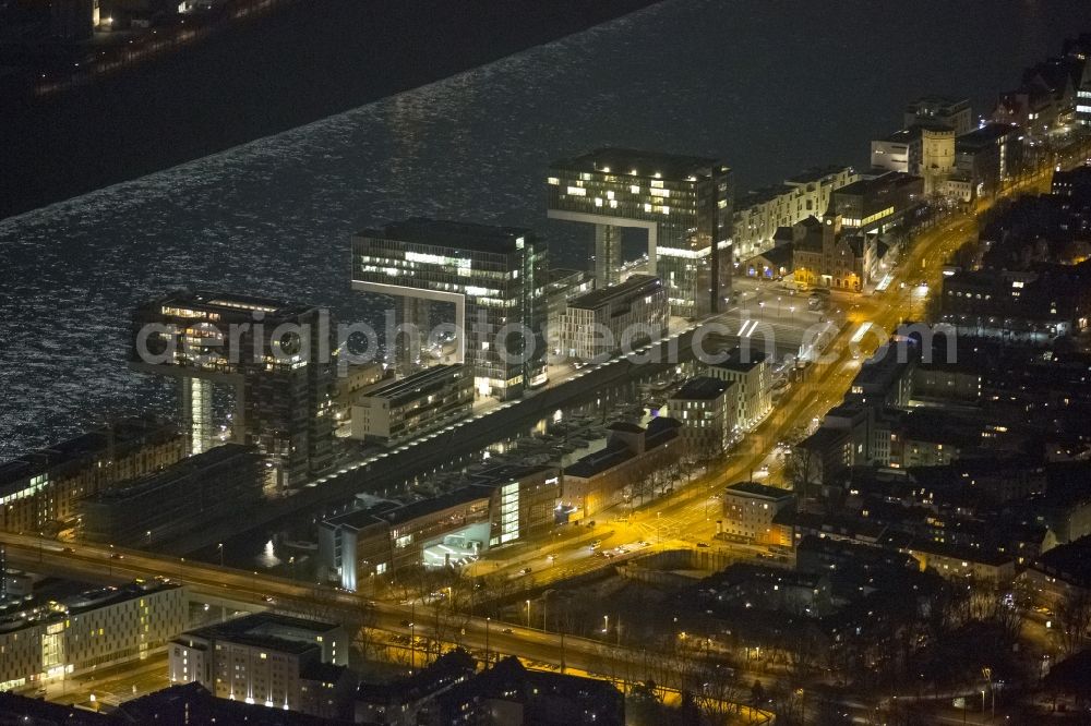 Aerial image at night Köln - Night view of new construction of houses on the crane Rheinauhafen on the banks of the Rhine in Cologne in North Rhine-Westphalia