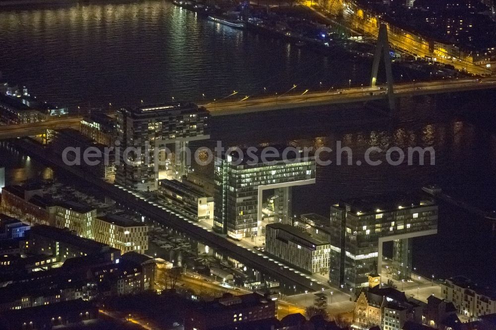 Köln at night from the bird perspective: Night view of new construction of houses on the crane Rheinauhafen on the banks of the Rhine in Cologne in North Rhine-Westphalia