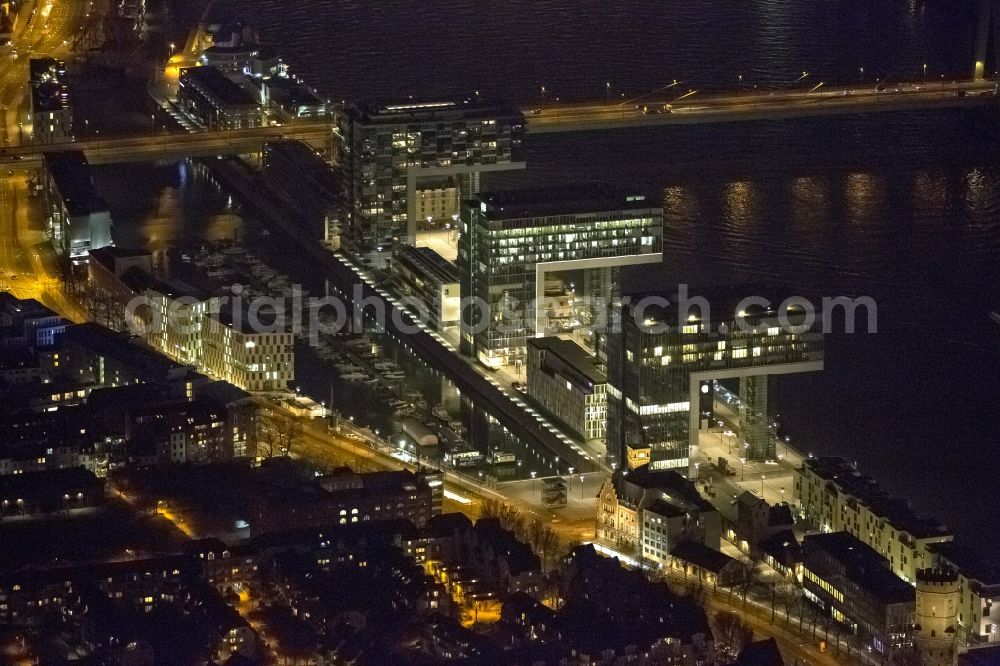 Aerial photograph at night Köln - Night view of new construction of houses on the crane Rheinauhafen on the banks of the Rhine in Cologne in North Rhine-Westphalia