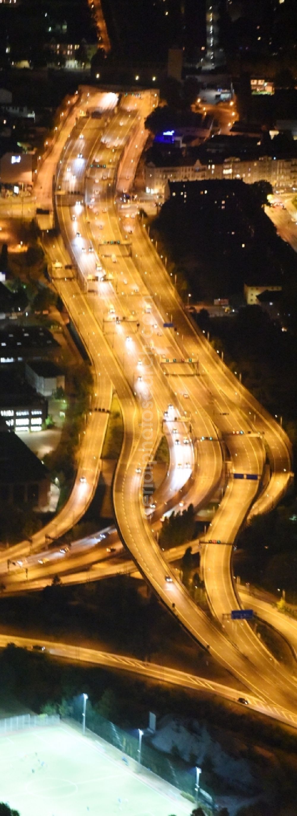 Aerial image at night Berlin - Night view routing and traffic lanes during the highway exit and access the motorway A 100 - 113 Grenzallee destrict Neukoelln in Berlin