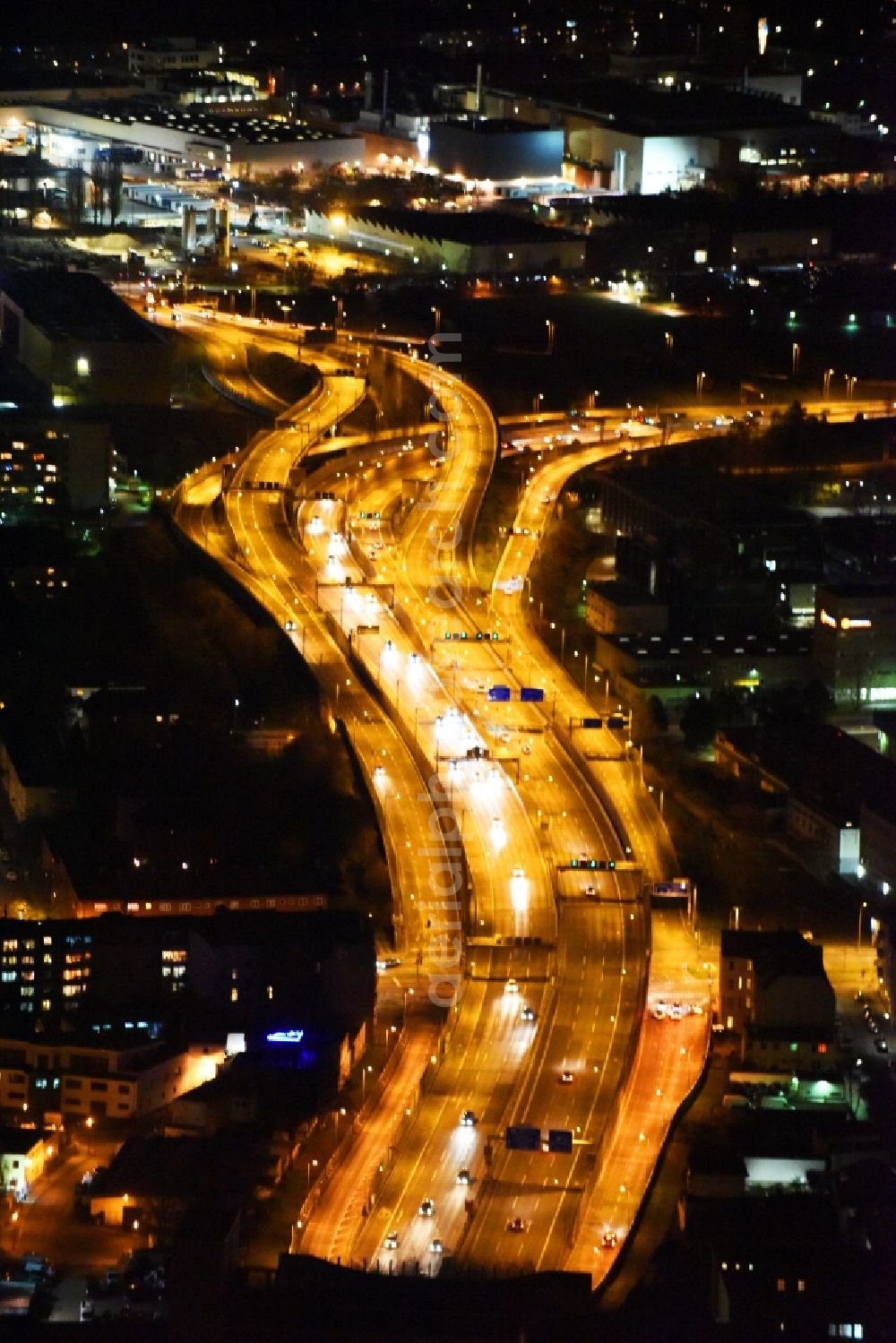 Berlin at night from the bird perspective: Night view routing and traffic lanes during the highway exit and access the motorway A 100 - 113 Grenzallee destrict Neukoelln in Berlin