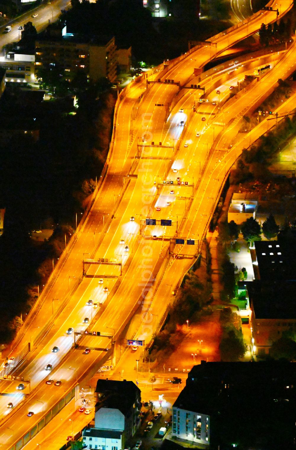 Aerial image at night Berlin - Night view routing and traffic lanes during the highway exit and access the motorway A 100 - 113 Grenzallee destrict Neukoelln in Berlin