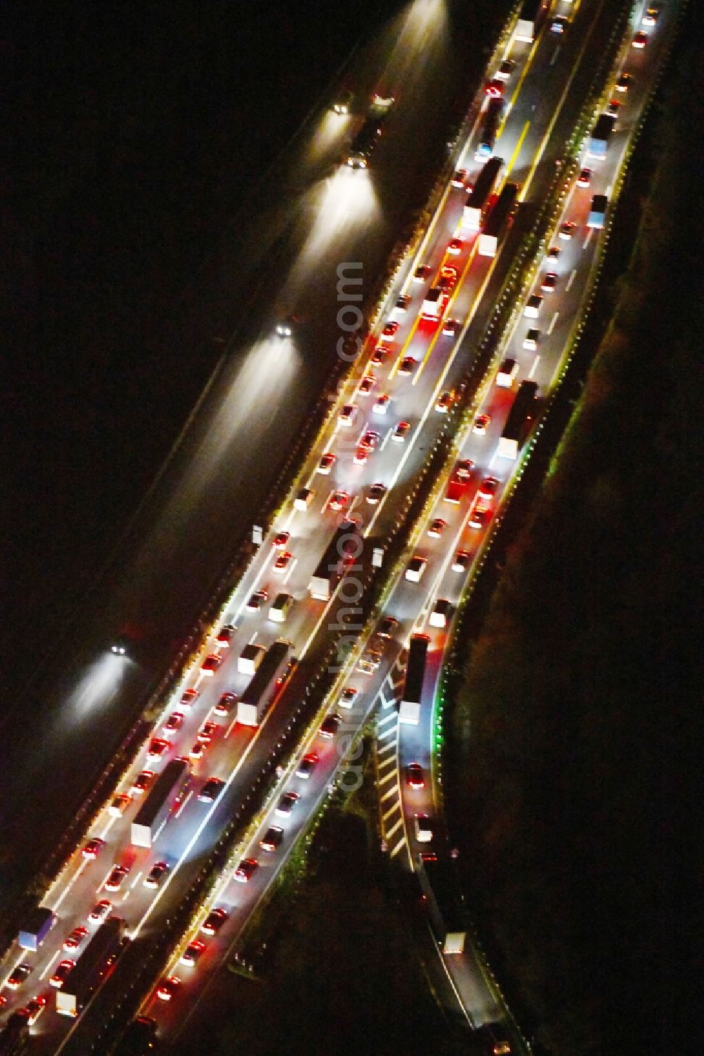 Ludwigsfelde at night from above - Night lighting Routing and traffic lanes during the highway exit and access the motorway A 10 to the L101 in Ludwigsfelde in the state Brandenburg, Germany