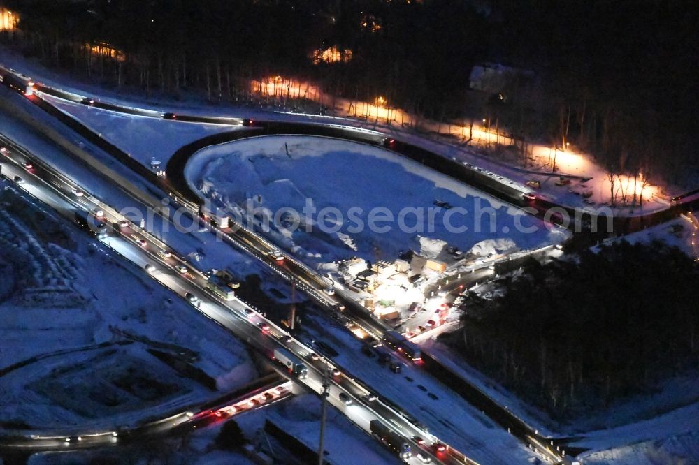 Wildenbruch at night from the bird perspective: Night view Motorway Construction and wheel spacers along the route of the motorway A10 to 8-lane track extension in Michendorf in Brandenburg