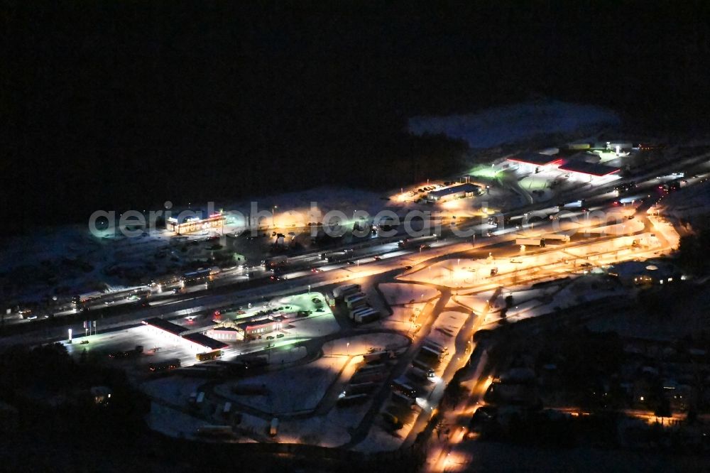 Aerial image at night Michendorf - Night view wintry snowy Motorway service area on the edge of the course of BAB highway A10 Michendorf-Sued in the district Michendorf in Michendorf in the state Brandenburg