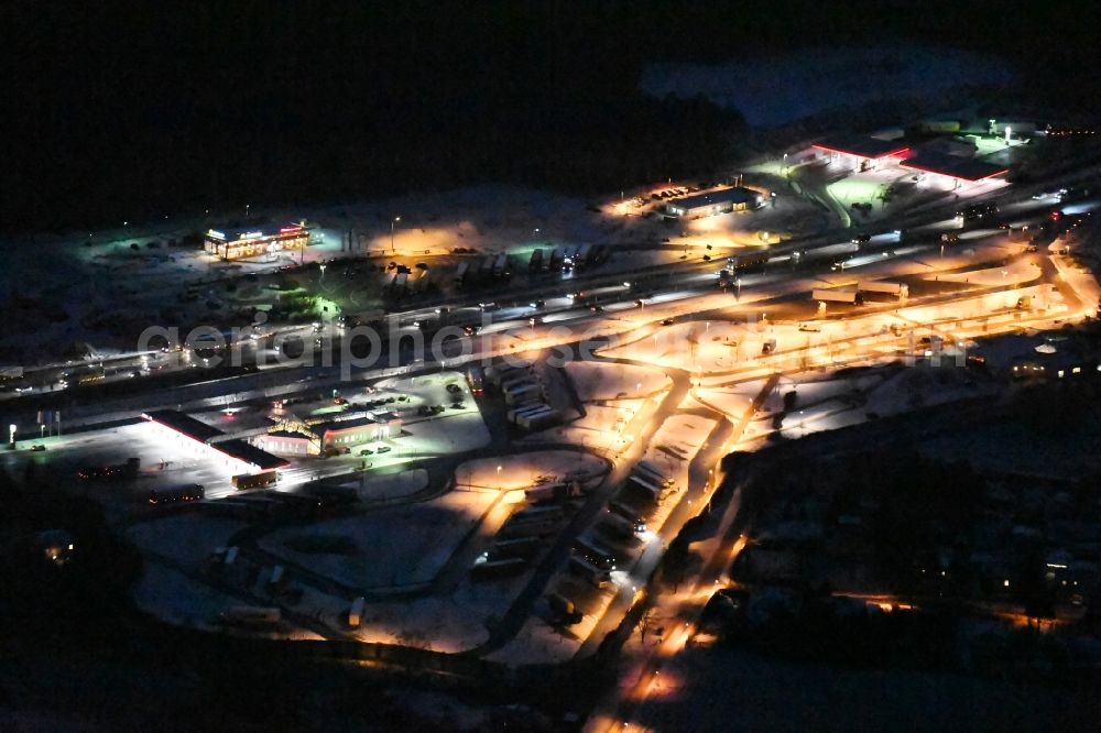 Michendorf at night from above - Night view wintry snowy Motorway service area on the edge of the course of BAB highway A10 Michendorf-Sued in the district Michendorf in Michendorf in the state Brandenburg