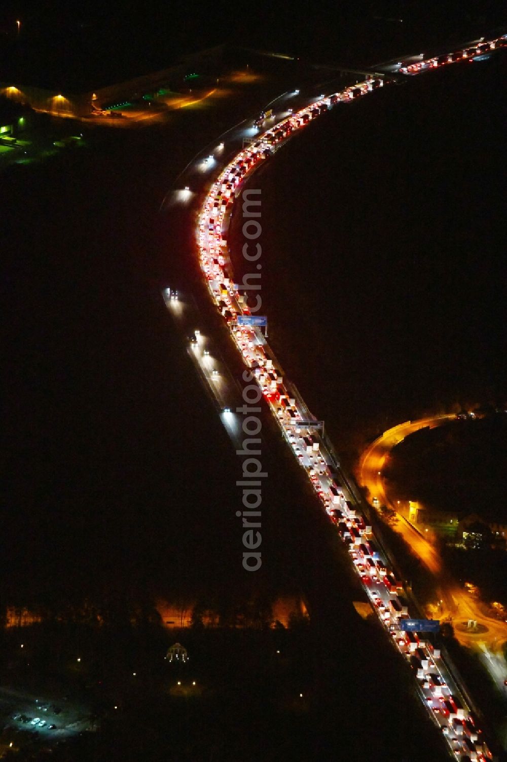 Aerial image at night Ludwigsfelde - Night lighting Highway congestion along the route of the lanes BAB A10 in Ludwigsfelde in the state Brandenburg, Germany