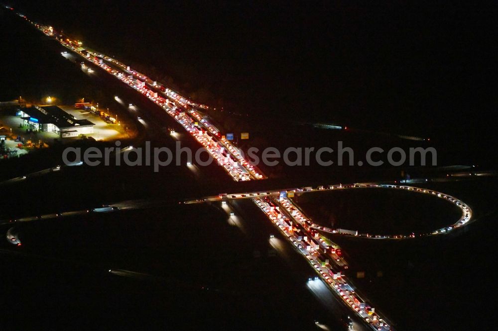 Aerial image at night Ludwigsfelde - Night lighting Highway congestion along the route of the lanes BAB A10 in Ludwigsfelde in the state Brandenburg, Germany