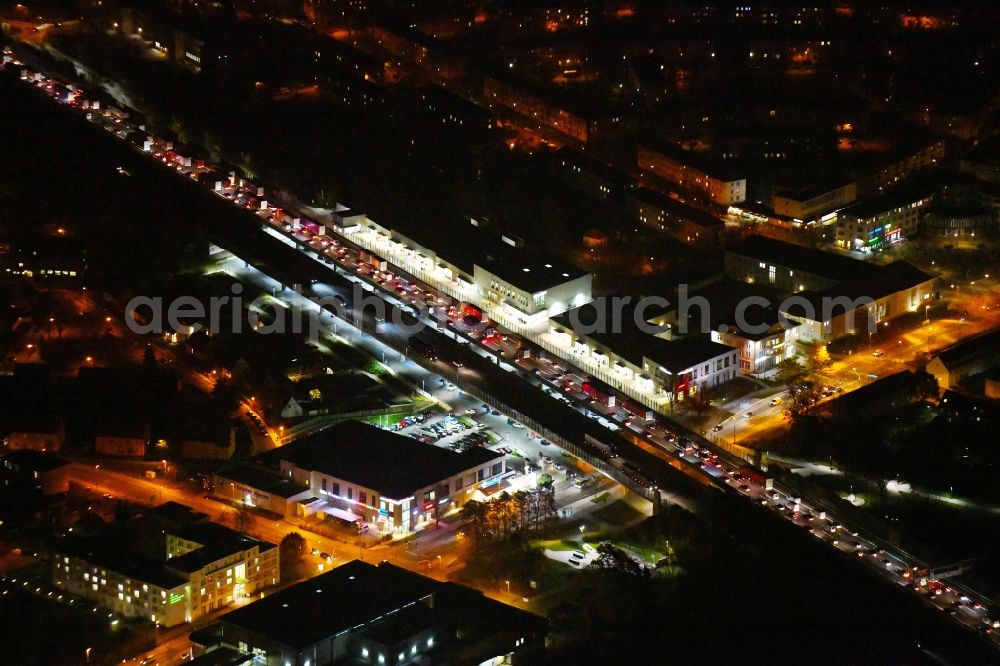 Aerial photograph at night Ludwigsfelde - Night lighting Lanes of the motorway- route and course of the A10 in Ludwigsfelde in the state Brandenburg, Germany