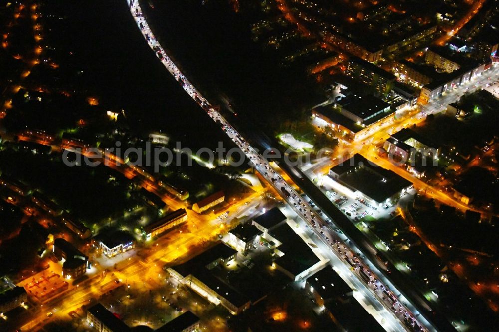 Aerial photograph at night Ludwigsfelde - Night lighting Lanes of the motorway- route and course of the A10 in Ludwigsfelde in the state Brandenburg, Germany