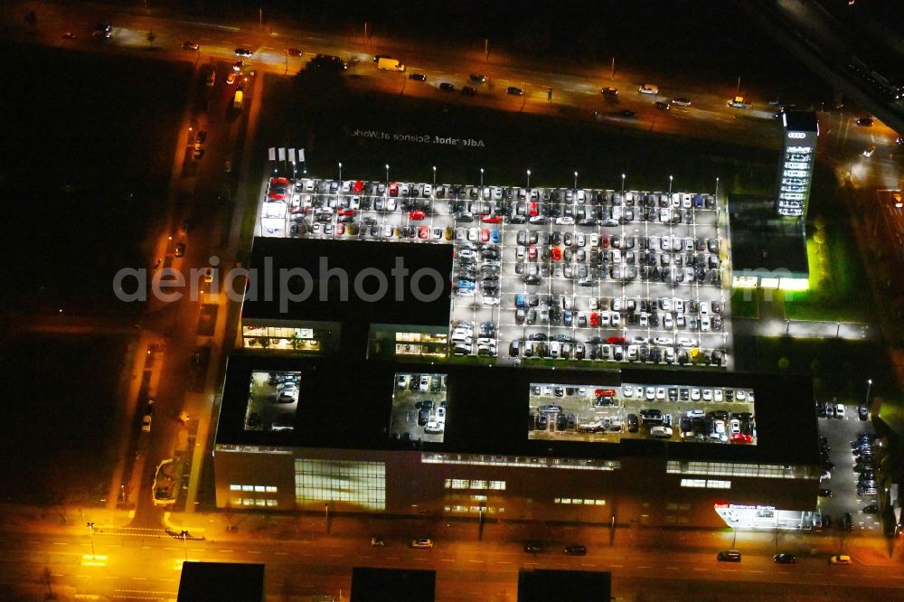 Aerial image at night Berlin - Night lighting Car dealership building Audi Zentrum Adlershof on Rudower Strasse in the district Adlershof in Berlin, Germany