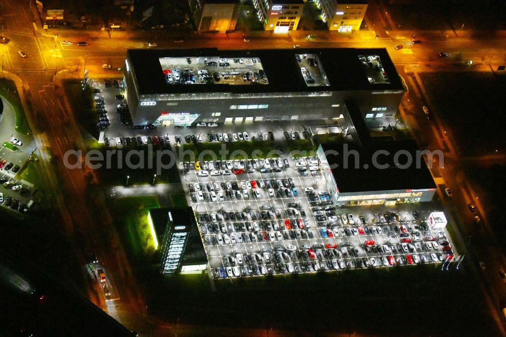 Aerial photograph at night Berlin - Night lighting Car dealership building Audi Zentrum Adlershof on Rudower Strasse in the district Adlershof in Berlin, Germany