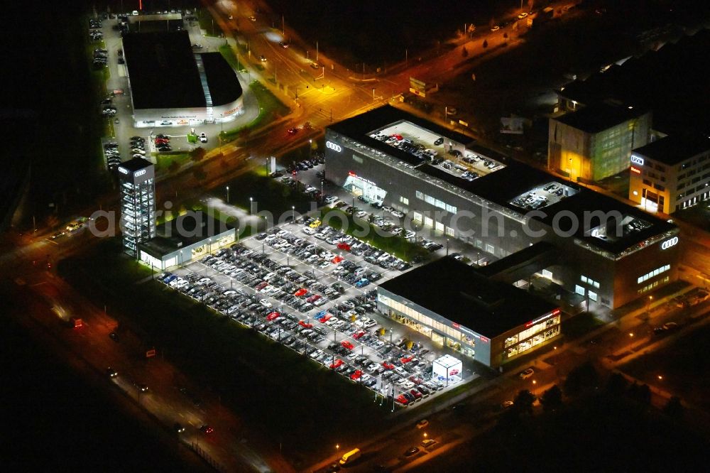 Berlin at night from the bird perspective: Night lighting Car dealership building Audi Zentrum Adlershof on Rudower Strasse in the district Adlershof in Berlin, Germany