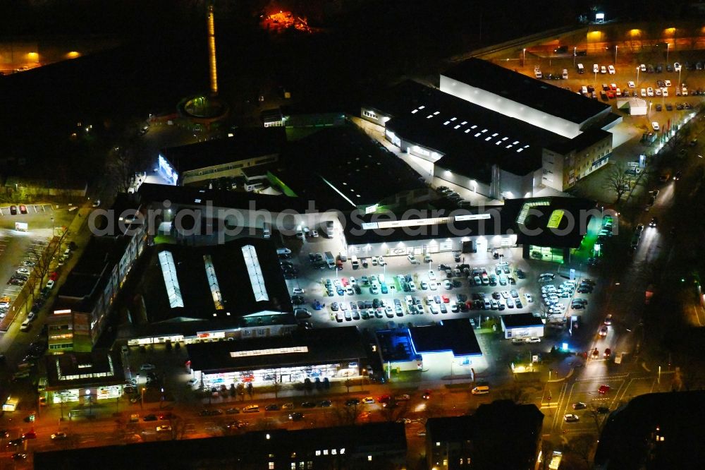 Aerial image at night Berlin - Night lighting Car dealership building Audi Zentrum Berlin Tegel in the district Reinickendorf in Berlin, Germany