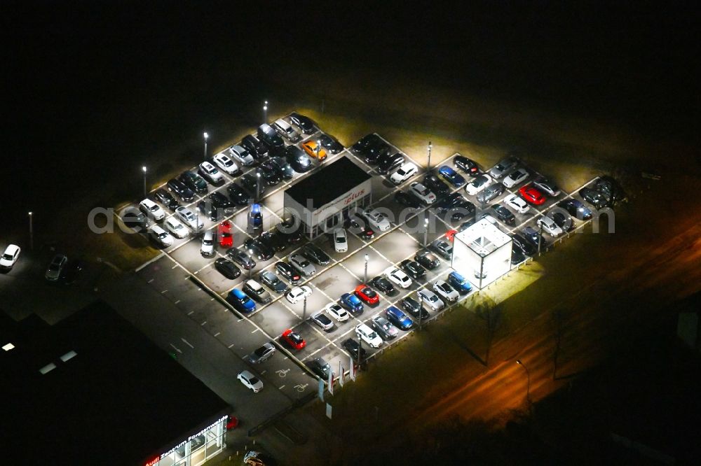 Fürstenwalde/Spree at night from above - Night lighting Car dealership building Audi Zentrum Fuerstenwalde on Langewahler Strasse in Fuerstenwalde/Spree in the state Brandenburg, Germany