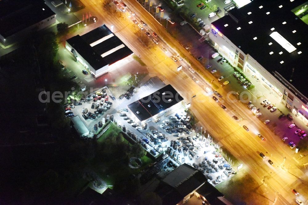 Aerial image at night Berlin - Night view car dealership building Autocenter Biesdorf Alt-Mahlsdorf in Berlin