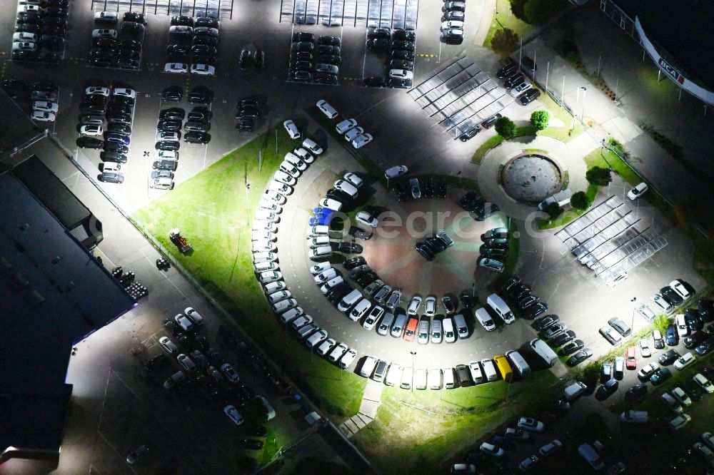 Aerial image at night Hoppegarten - Night lighting car dealership building Automobile BCA Autoauktionen GmbH and DUeRKOP GmbH Neuer Hoenower Weg in Hoppegarten in the state Brandenburg