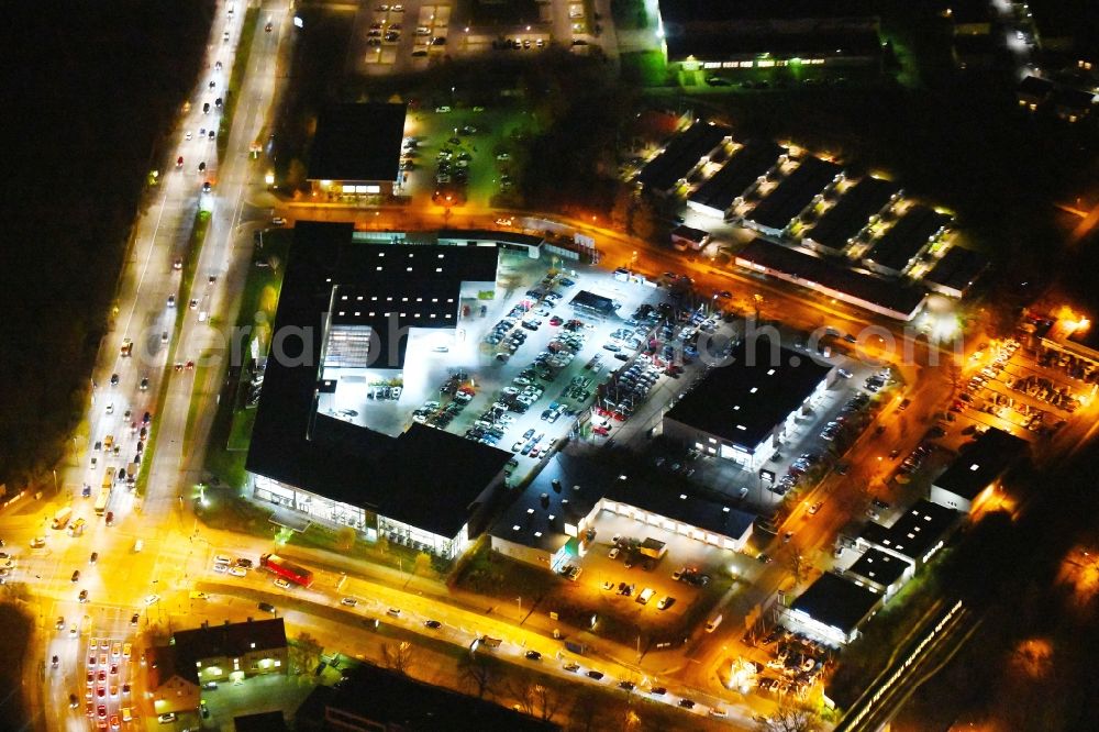 Aerial photograph at night Berlin - Night lighting Car dealership building BMW Niederlassung Filiale Marzahn Berlin on Blumberger Donm in the district Biesdorf in Berlin, Germany