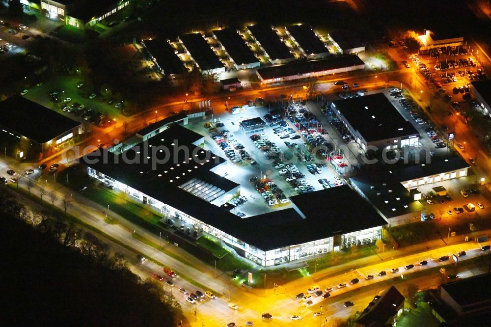 Berlin at night from above - Night lighting Car dealership building BMW Niederlassung Filiale Marzahn Berlin on Blumberger Donm in the district Biesdorf in Berlin, Germany