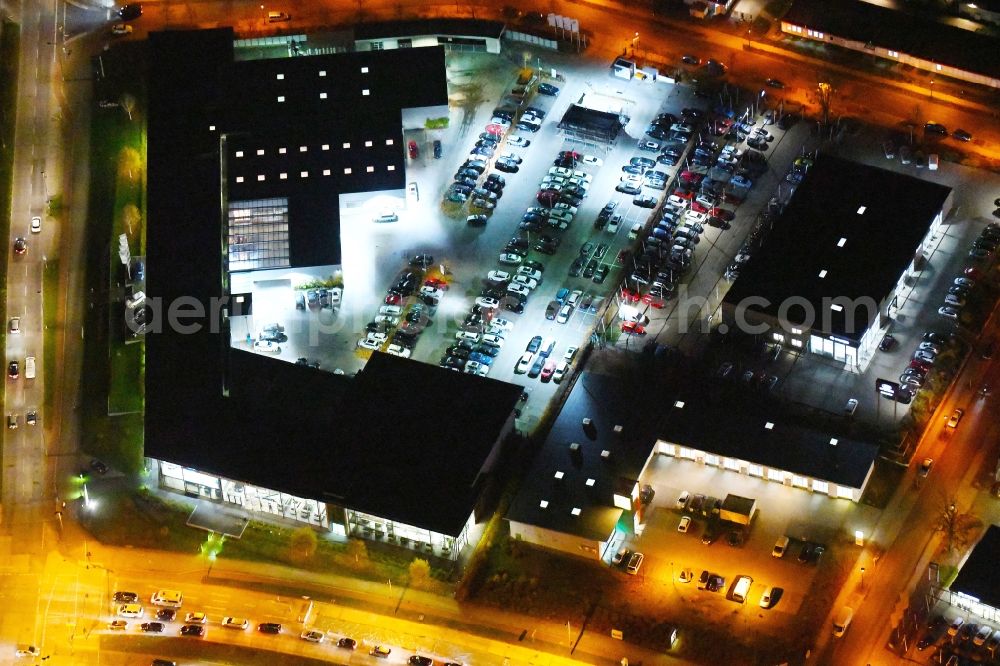 Aerial photograph at night Berlin - Night lighting Car dealership building BMW Niederlassung Filiale Marzahn Berlin on Blumberger Donm in the district Biesdorf in Berlin, Germany