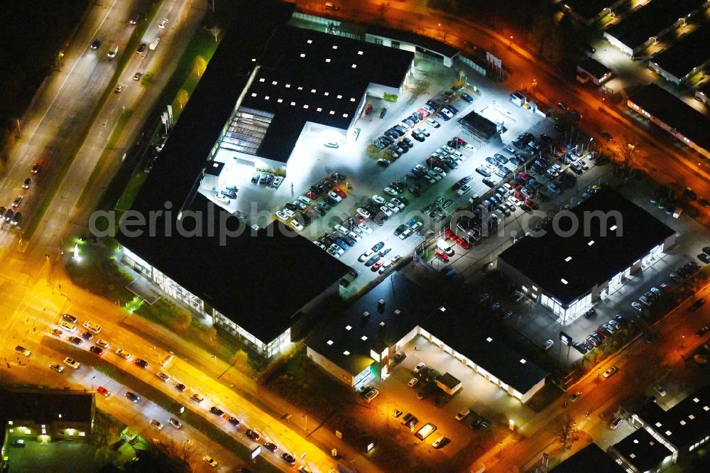 Berlin at night from above - Night lighting Car dealership building BMW Niederlassung Filiale Marzahn Berlin on Blumberger Donm in the district Biesdorf in Berlin, Germany