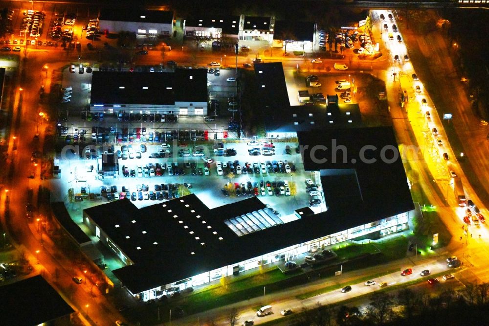 Aerial photograph at night Berlin - Night lighting Car dealership building BMW Niederlassung Filiale Marzahn Berlin on Blumberger Donm in the district Biesdorf in Berlin, Germany