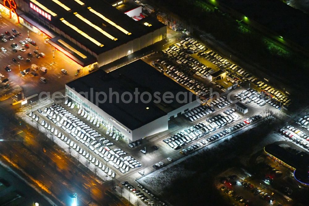 Barsbüttel at night from the bird perspective: Night lighting car dealership building BMW Niederlassung Hamburg on Rahlstedter Strasse in Barsbuettel in the state Schleswig-Holstein, Germany