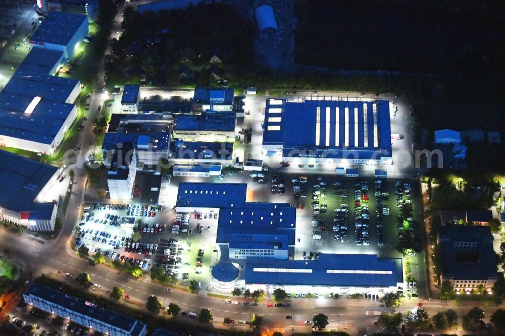 Berlin at night from above - Night lighting car dealership building of Volkswagen Automobile Berlin GmbH on Goerzallee in the district Lichterfelde in Berlin, Germany